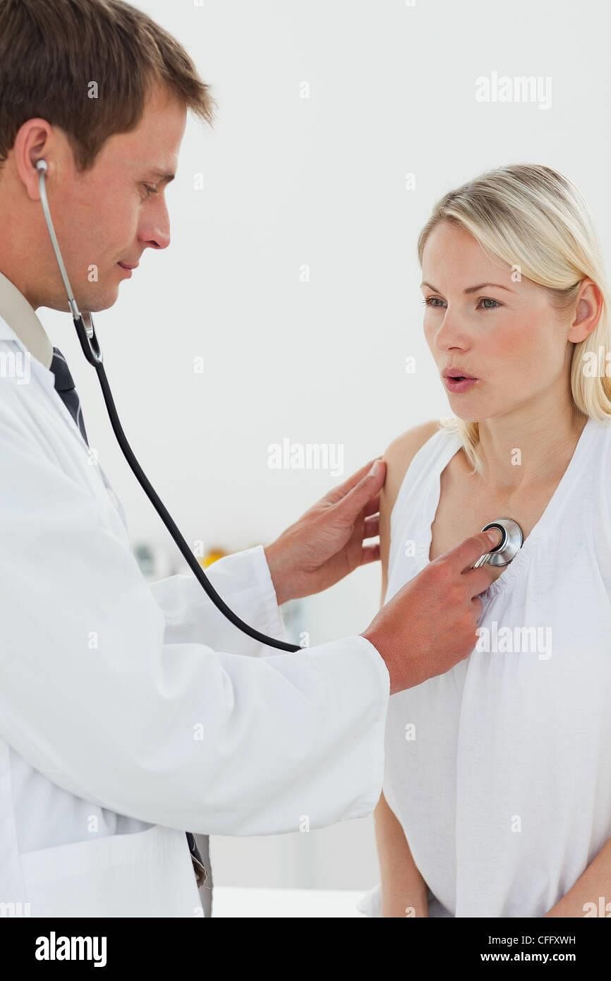 Doctor checking his patients heart beat Stock Photo - Alamy